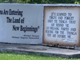 Stone monument says "You are entering into the land of new beginnings